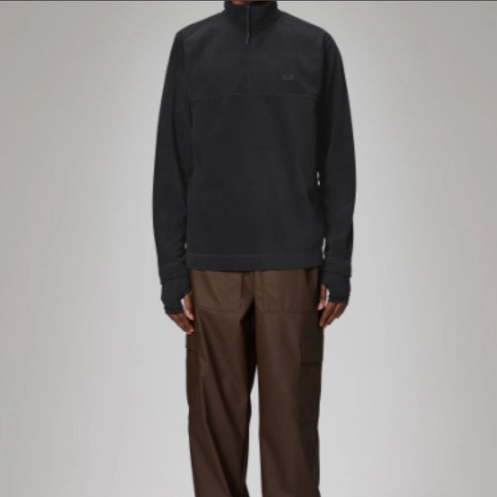 Black half zip up large fleece. Rains.